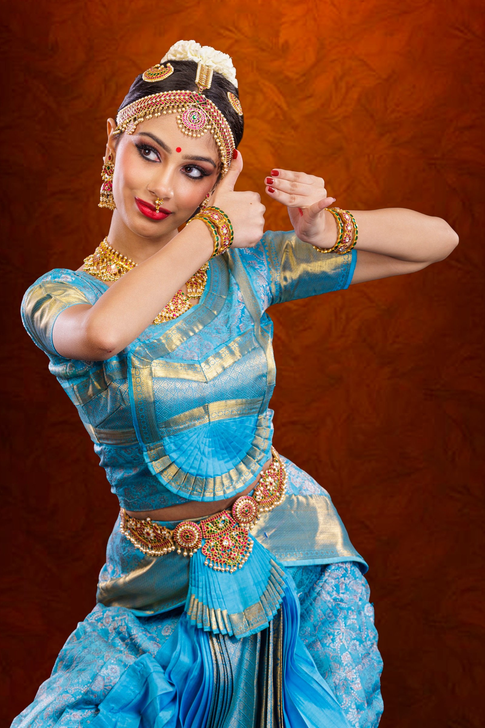 Ilesha in a twisting pose, one arm raised behind her head