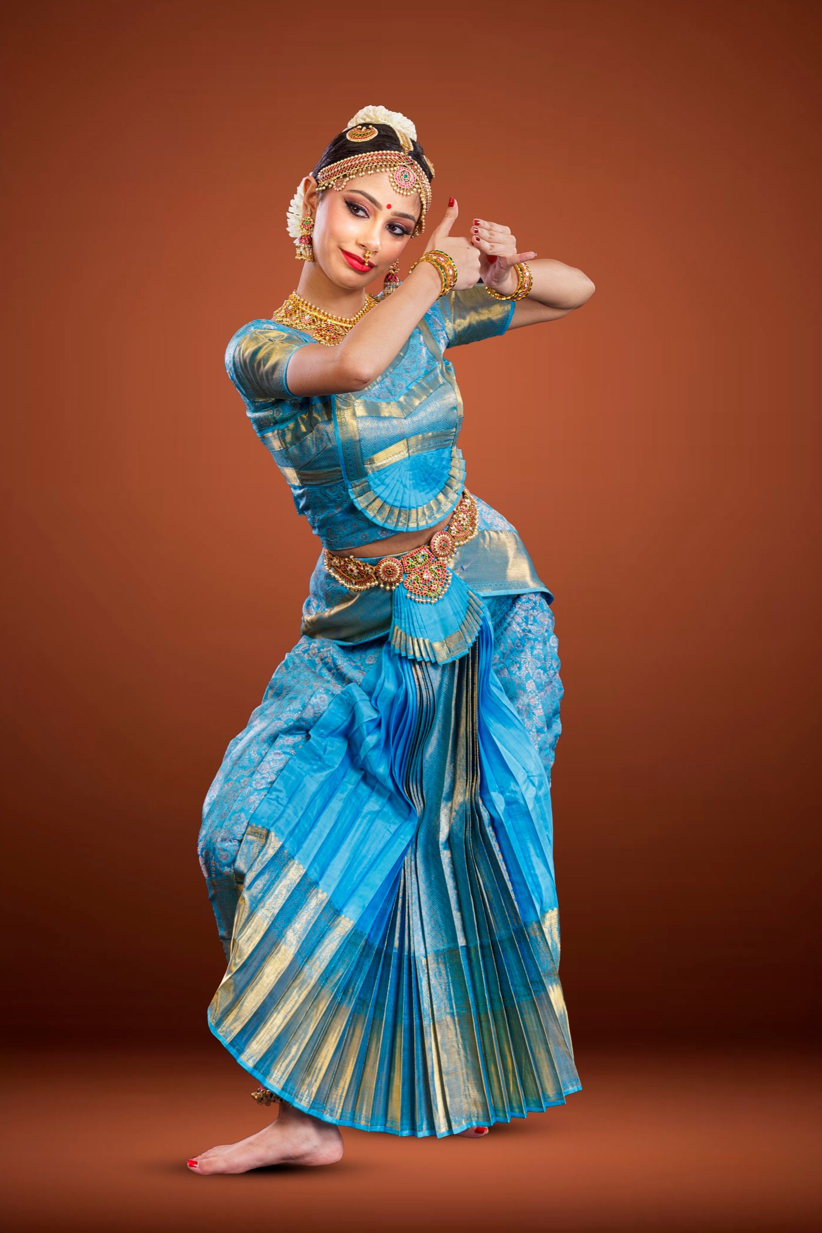 Ilesha with both arms framing her head in a deep side bend