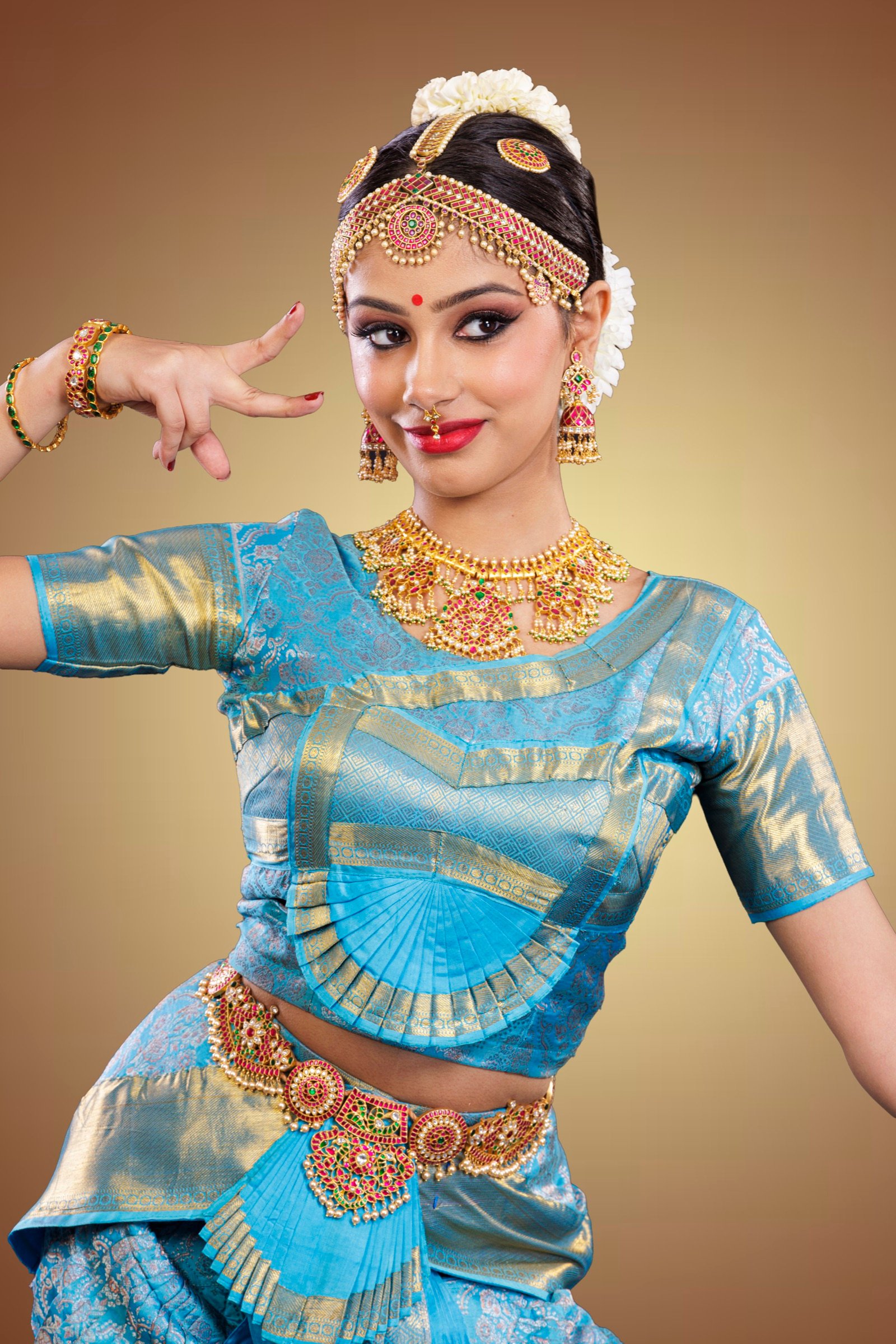 Ilesha smiling with a pointed hand gesture near her face