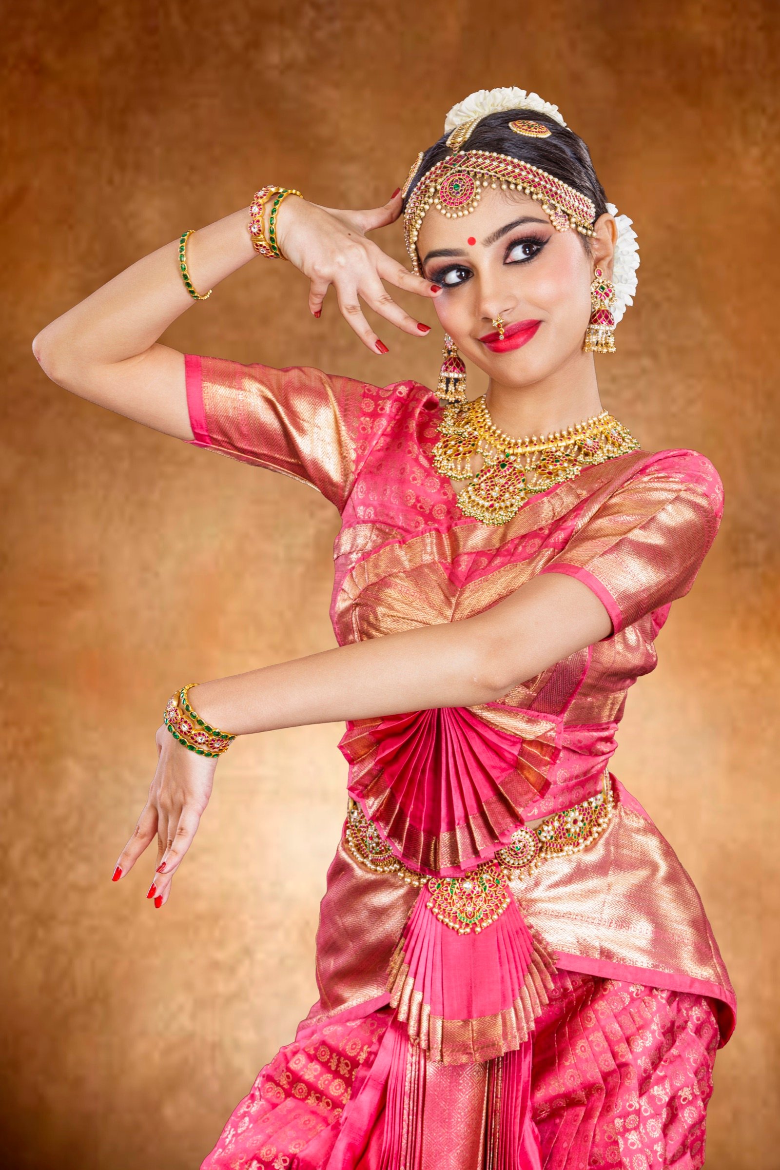 Ilesha with fanned hand gestures held near her face