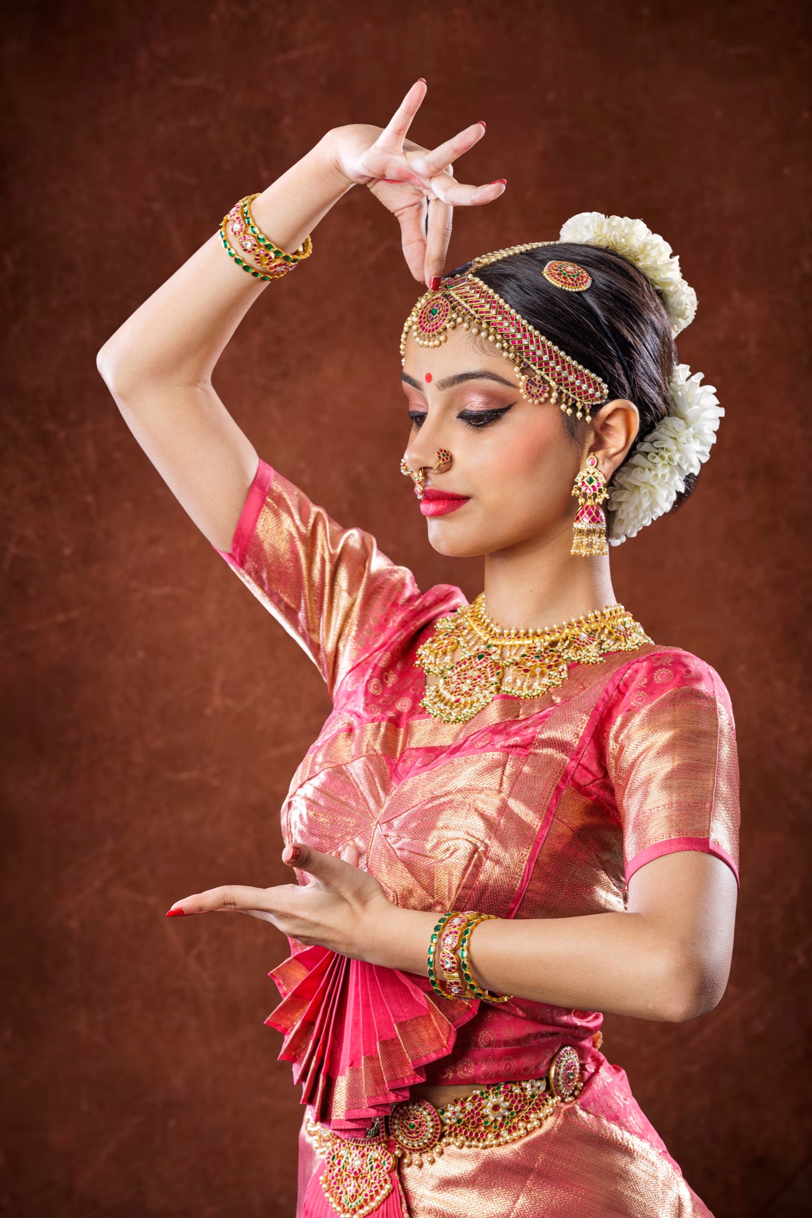 Profile of Ilesha with one hand overhead and one at her chest