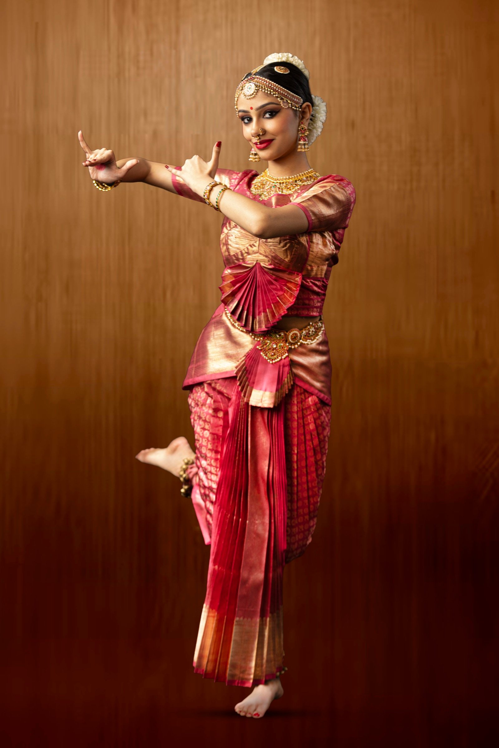 Ilesha balancing with one foot lifted, hands in matching mudra