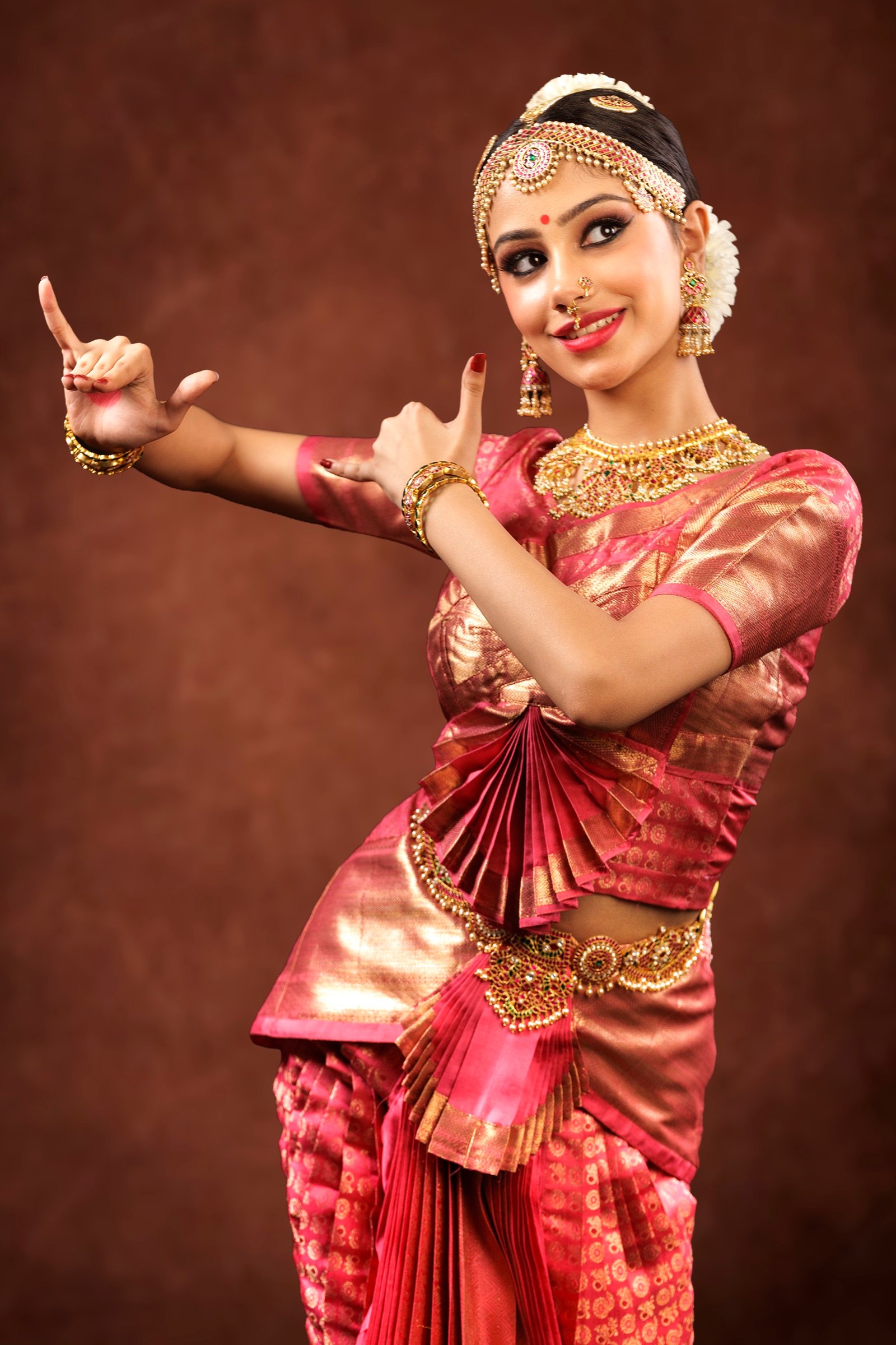 Ilesha with both hands in pointed gestures to one side